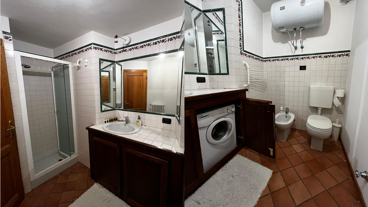 Bagno con doccia e lavatrice